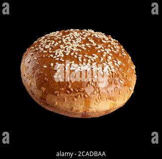 baked round bun with sesame seeds isolated on black background, hamburger ingredient Stock Photo