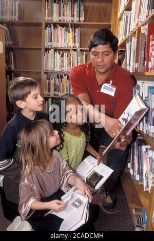 Austin, Texas USA:  Male librarian with first graders at Walnut Creek Elementary School. ©Bob Daemmrich Stock Photo