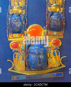 Egypt, Cairo, Tutankhamon jewellery, from his tomb in Luxor : A complex flexible pectoral showing a barque, solar snakes and a scarab. Stock Photo