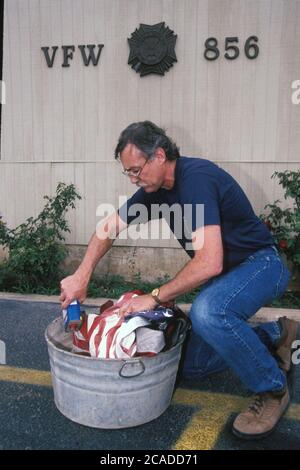 Anglo male veteran shows proper way to dispose of old American flags at VFW (Veterans of Foreign Wars) hall in Austin, Texas. ©Bob Daemmrich Stock Photo