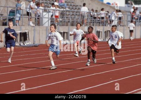 Austin Texas USA: Boys compete in 100-meter dash at citywide track meet for elementary school students. ©Bob Daemmrich Stock Photo