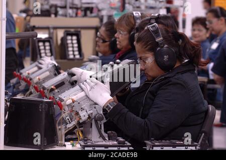 Matamoros, Mexico April, 2006: Car radios being manufactured at Delphi Delco Electronics de Mexico, a maquiladora plant across the United States border from Brownsville, Texas, that makes parts for General Motors cars. Delphi has about 11,000 Mexican workers in seven factories near Matamoros. ©Bob Daemmrich Stock Photo