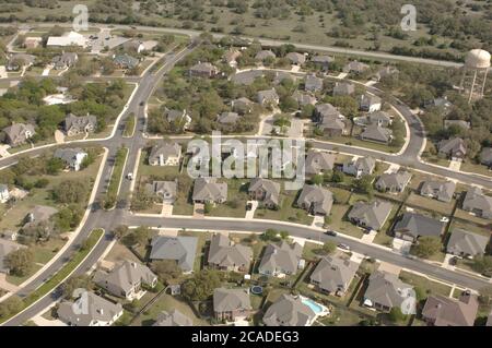 Austin, Texas USA, April, 2006: Aerial view of suburban middle-class neighborhood in Round Rock, a northern suburb of Austin, where new homes encroach on farming and pasture land. Stock Photo