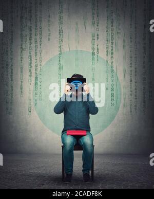 E-learning concept, young man, student or teacher seated with a book on knees, cover his head using a PC tablet with wifi symbol on the screen. Modern Stock Photo