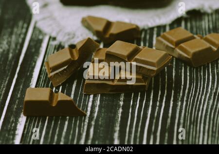 Group of chocolate bars different colors. Different kind assorted sweets. Assorted chocolate on rustic wooden background. Chocolate bars of different Stock Photo