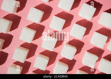 Cubes of sugar on a pink background Stock Photo