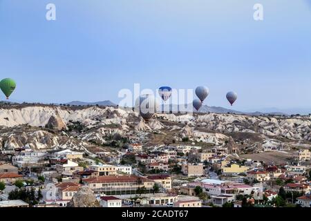 Goreme, Cappadocia, Turkey - May 08, 2014: Kapadokya Hot air balloons flying over famous rock formations landscape of Goreme National Park in Cappadoc Stock Photo