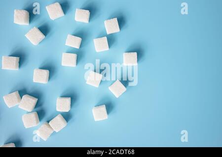Top view of white sugar cubes on blue Stock Photo
