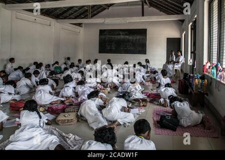 KANDY, SRI LANKA - JANUARY 31, 2016: Lesson education in school room Sri lankan teacher writes on the blackboard, Young school Kandy Sri Lanka. Stock Photo