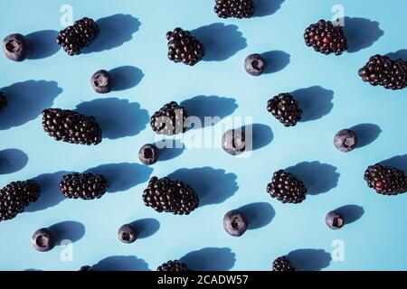 Fresh summer pattern with berries on blue table Stock Photo