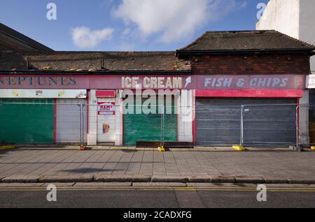 Closed down and boarded-up ice cream parlour and shops in Herne Bay, Kent, England. Stock Photo