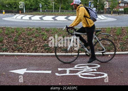 Cambridge, UK - 6 August 2020 UK's first Dutch-style roundabout in Cambridge near Addenbrooke's Hospital that gives priority to bicycles. Cambridgeshire County Council's £2.3million project gives cyclists an outer ring on the roundabout, with cycle crossings over each of the four approach roads in a contrasting red surface, and motorists must give way to pedestrians and cyclists when joining and leaving the roundabout.  Credit: Nils Jorgensen/Alamy Live News Stock Photo