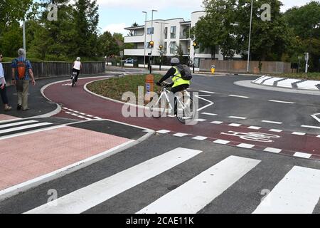 Cambridge, UK - 6 August 2020 UK's first Dutch-style roundabout in Cambridge near Addenbrooke's Hospital that gives priority to bicycles. Cambridgeshire County Council's £2.3million project gives cyclists an outer ring on the roundabout, with cycle crossings over each of the four approach roads in a contrasting red surface, and motorists must give way to pedestrians and cyclists when joining and leaving the roundabout.  Credit: Nils Jorgensen/Alamy Live News Stock Photo