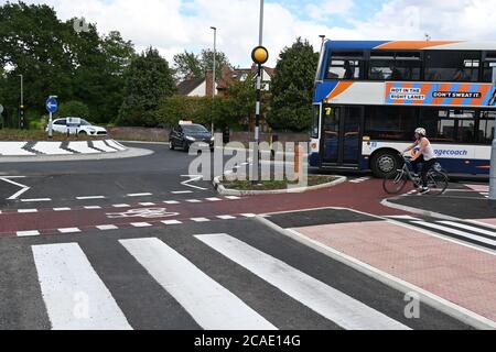 Cambridge, UK - 6 August 2020 UK's first Dutch-style roundabout in Cambridge near Addenbrooke's Hospital that gives priority to bicycles. Cambridgeshire County Council's £2.3million project gives cyclists an outer ring on the roundabout, with cycle crossings over each of the four approach roads in a contrasting red surface, and motorists must give way to pedestrians and cyclists when joining and leaving the roundabout.  Credit: Nils Jorgensen/Alamy Live News Stock Photo