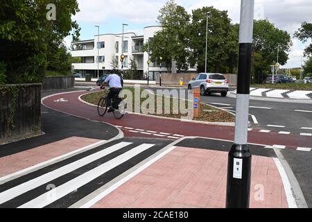 Cambridge, UK - 6 August 2020 UK's first Dutch-style roundabout in Cambridge near Addenbrooke's Hospital that gives priority to bicycles. Cambridgeshire County Council's £2.3million project gives cyclists an outer ring on the roundabout, with cycle crossings over each of the four approach roads in a contrasting red surface, and motorists must give way to pedestrians and cyclists when joining and leaving the roundabout.  Credit: Nils Jorgensen/Alamy Live News Stock Photo