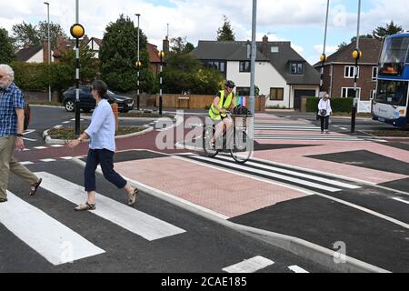 Cambridge, UK - 6 August 2020 UK's first Dutch-style roundabout in Cambridge near Addenbrooke's Hospital that gives priority to bicycles. Cambridgeshire County Council's £2.3million project gives cyclists an outer ring on the roundabout, with cycle crossings over each of the four approach roads in a contrasting red surface, and motorists must give way to pedestrians and cyclists when joining and leaving the roundabout.  Credit: Nils Jorgensen/Alamy Live News Stock Photo