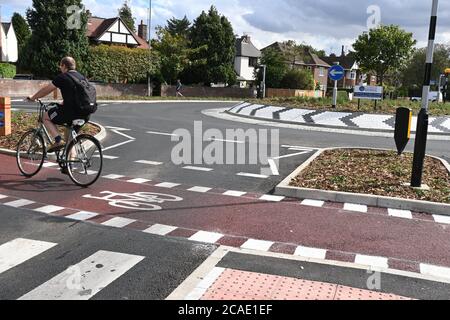 Cambridge, UK - 6 August 2020 UK's first Dutch-style roundabout in Cambridge near Addenbrooke's Hospital that gives priority to bicycles. Cambridgeshire County Council's £2.3million project gives cyclists an outer ring on the roundabout, with cycle crossings over each of the four approach roads in a contrasting red surface, and motorists must give way to pedestrians and cyclists when joining and leaving the roundabout.  Credit: Nils Jorgensen/Alamy Live News Stock Photo