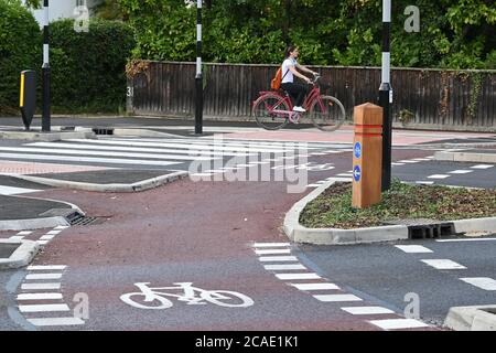 Cambridge, UK - 6 August 2020 UK's first Dutch-style roundabout in Cambridge near Addenbrooke's Hospital that gives priority to bicycles. Cambridgeshire County Council's £2.3million project gives cyclists an outer ring on the roundabout, with cycle crossings over each of the four approach roads in a contrasting red surface, and motorists must give way to pedestrians and cyclists when joining and leaving the roundabout.  Credit: Nils Jorgensen/Alamy Live News Stock Photo