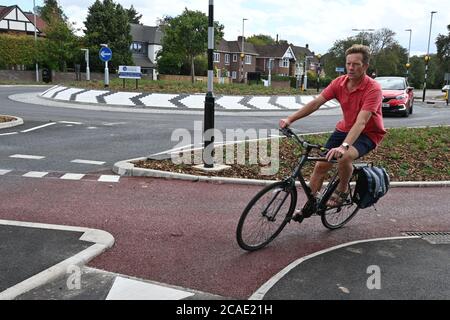 Cambridge, UK - 6 August 2020 UK's first Dutch-style roundabout in Cambridge near Addenbrooke's Hospital that gives priority to bicycles. Cambridgeshire County Council's £2.3million project gives cyclists an outer ring on the roundabout, with cycle crossings over each of the four approach roads in a contrasting red surface, and motorists must give way to pedestrians and cyclists when joining and leaving the roundabout.  Credit: Nils Jorgensen/Alamy Live News Stock Photo