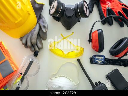 Work safety protection equipment flat lay. Industrial protective gear on white background, top view. Construction site health and safety concept Stock Photo