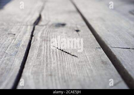 background old gray wooden floor made of planks and deep holes Stock Photo