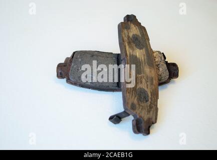 pair of worn out ruined disc brake pads Stock Photo