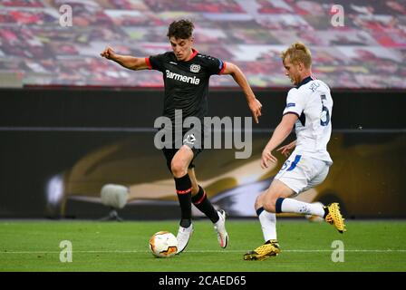 Bayer 04 Leverkusen's Kai Havertz (left) and Rangers' Filip Helander battle for the ball during the UEFA Europa League, Quarter Final match at the BayArena, Leverkusen. Stock Photo