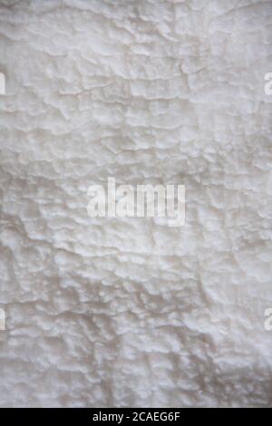White soft wool background, detail of a natural sheepskin rug. Stock Photo