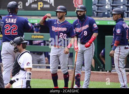 Minnesota Twins' Eddie Rosario, right, scores past Los Angeles Angels ...