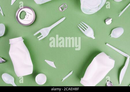 Eco plastic recycling concept. Single use plastics on green background. Stock Photo