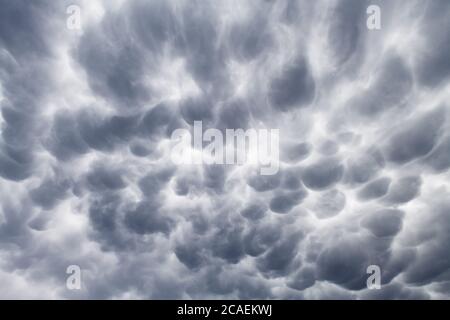 Stormy sky with menacing mammatus clouds before the storm. Climate change nature background Stock Photo