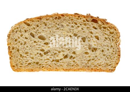 Slice of spelt bread, from above. Brown sourdough bread, a mix of spelt flour, leaven, sunflower seeds and spices, baked in oven. Staple food. Stock Photo