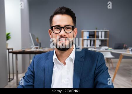 Smiling Man Portrait At Workplace In Office Stock Photo