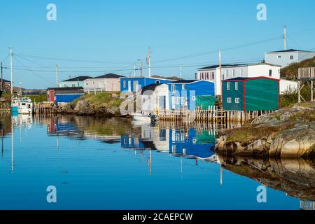 Fishing village buildings and boats reflected in the inner harbour, Rose Blanche, Newfoundland and Labrador NL, Canada