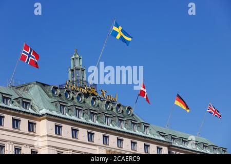 Stockholm, Sweden - July 31, 2020: The top floors of the Grand Hotel with its hoisted flags representing Norway, Sweden, Denmark,Germany and Great Bri Stock Photo