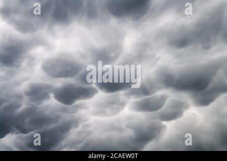 Stormy sky with menacing mammatus clouds before the storm. Climate change nature background Stock Photo