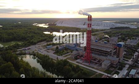 Air pollution by smoke coming out of factory chimneys. Bird's-eye view of the industrial zone in the Leningrad region Stock Photo