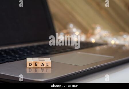 DEAL letter blocks business finance concept on laptop keyboard Stock Photo