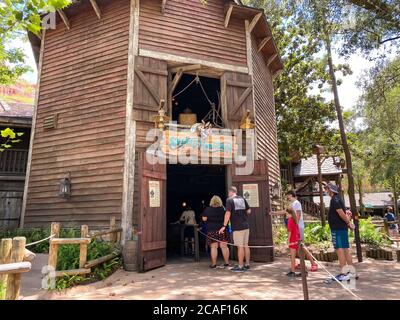 Orlando,FL/USA- 7/25/20: People at the entrance to the Splash Mountain ride wearing face masks and social distancing at Walt Disney World in Orlando, Stock Photo