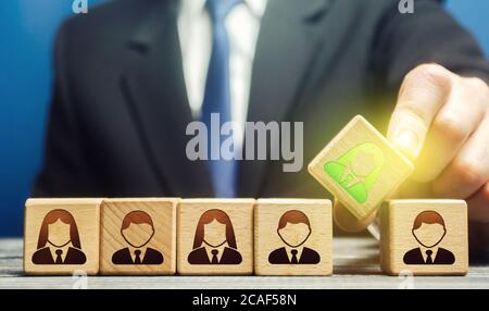 A businessman appoints a leader to a team. Leadership skills. Promising talented employee. Formation effective working group. Implementation of specia Stock Photo