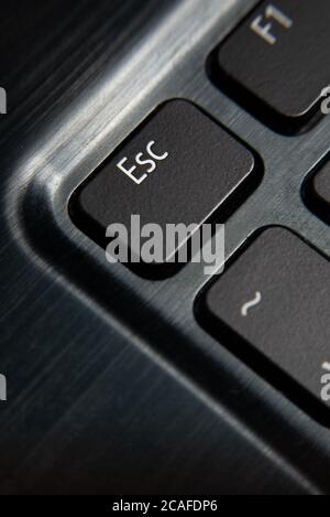 Vertical closeup shot of the black '"Esc" button on the keyboard Stock Photo