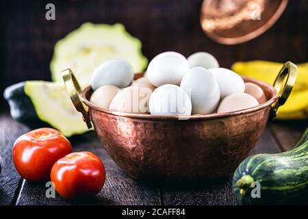 Brazilian free-range eggs, natural free-range eggs from Minas Gerais, in copper pots. Typical Brazilian cuisine. Stock Photo
