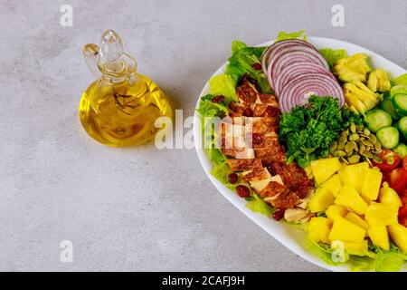 Colorful vegetable salad with herb olive oil in glass bottle. Stock Photo
