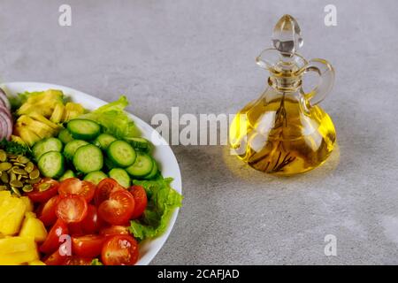 Vegetable salad with herb olive oil in glass bottle. Stock Photo