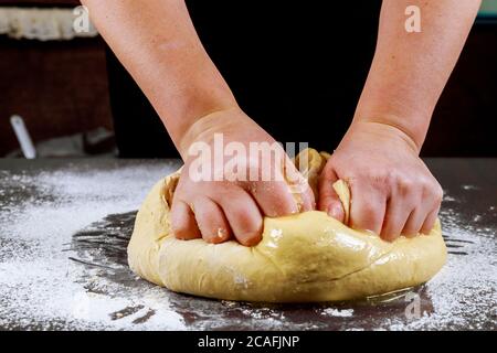 Woman kneading dough for making homemade pizza. Stock Photo