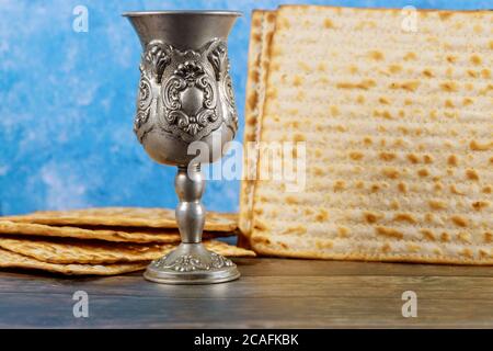 Matzos unleavened bread with kiddush cup of wine. Jewish pesah holiday. Stock Photo