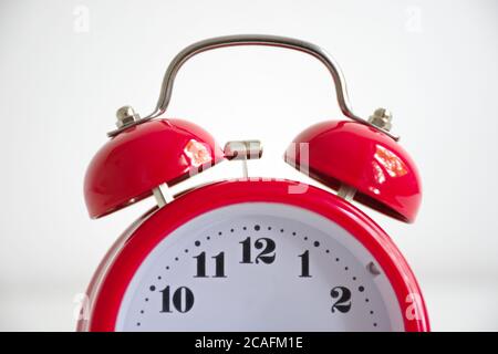 Red vintage alarm clock against the white background Stock Photo