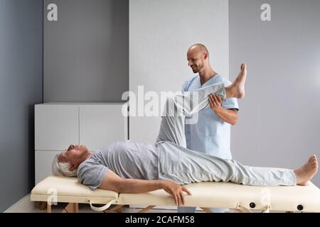 Doctor Doing Check And Physiotherapy Rehab After Injury Stock Photo