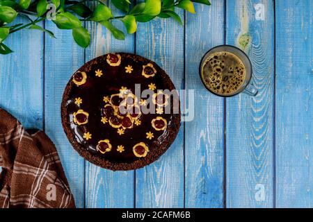 Chocolate cake with chocolate glaze on the top and cup of coffee. Stock Photo