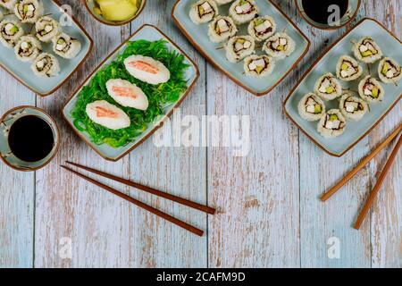 Chinese cuisine. Set of philadelphia sushi roll with soy sauce, ginger and chopstick. Stock Photo